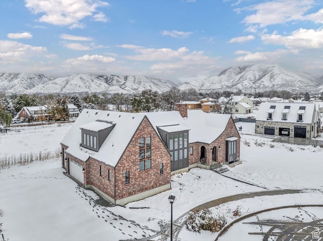 snowy aerial view featuring a mountain view