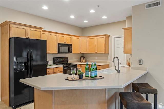 5012 S Timber Way E Unit 205, Holladay, UT 84117 - kitchen with sink, black appliances, a kitchen bar, kitchen peninsula, and light brown cabinets