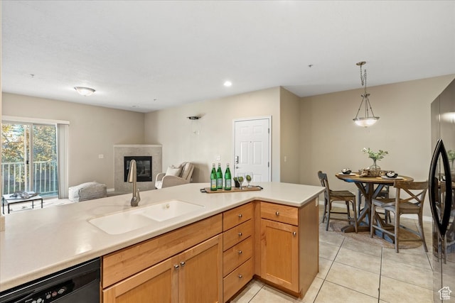 5012 S Timber Way E Unit 205, Holladay, UT 84117 - kitchen with pendant lighting, sink, a tile fireplace, black appliances, and light tile patterned flooring