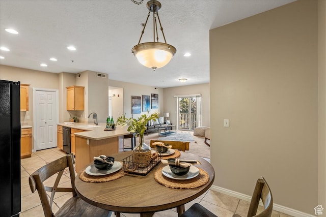5012 S Timber Way E Unit 205, Holladay, UT 84117 - dining room with light tile patterned flooring, sink, and a textured ceiling
