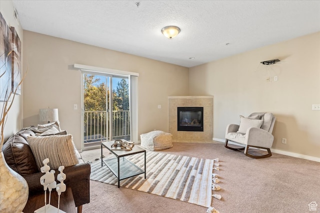 5012 S Timber Way E Unit 205, Holladay, UT 84117 - living area featuring a tiled fireplace, a textured ceiling, and carpet