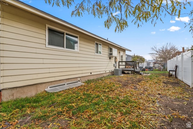 view of home's exterior with cooling unit and a wooden deck