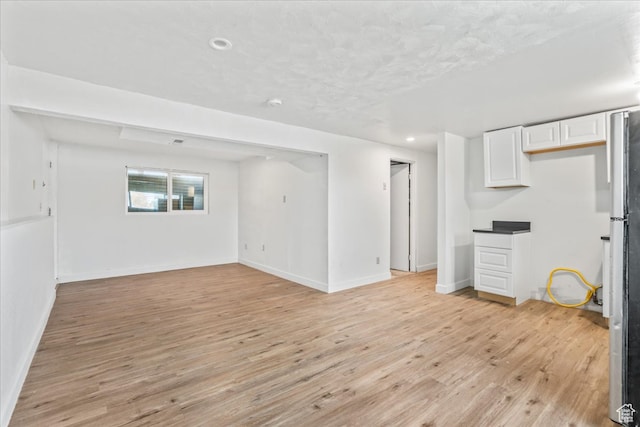 unfurnished living room with light hardwood / wood-style flooring