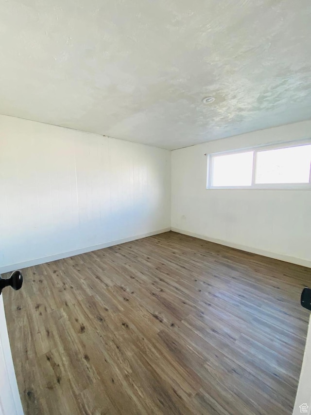 empty room with wood-type flooring
