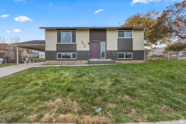 raised ranch with a carport and a front yard