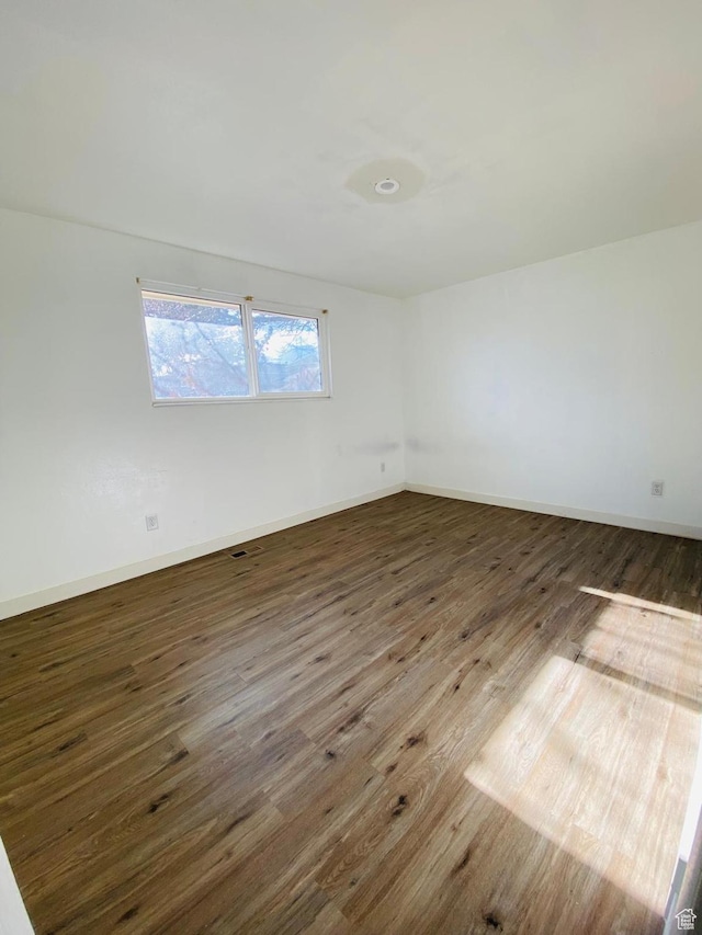 empty room featuring dark hardwood / wood-style floors