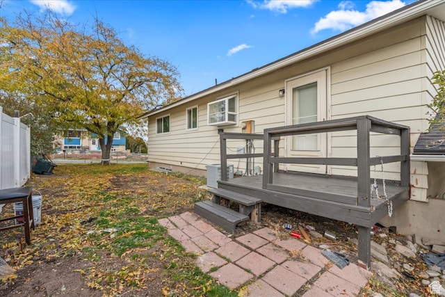 rear view of house with a wooden deck and central AC