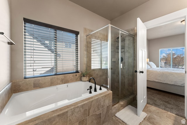 bathroom featuring tile patterned floors, plenty of natural light, and independent shower and bath