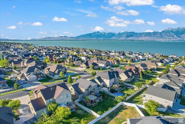 birds eye view of property with a water and mountain view