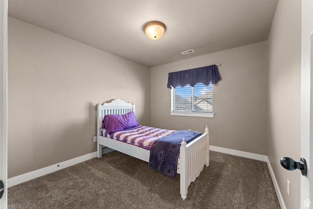 bedroom with dark colored carpet