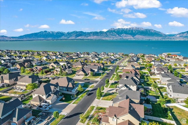 drone / aerial view featuring a water and mountain view