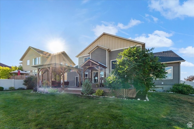 rear view of property with a lawn and a deck