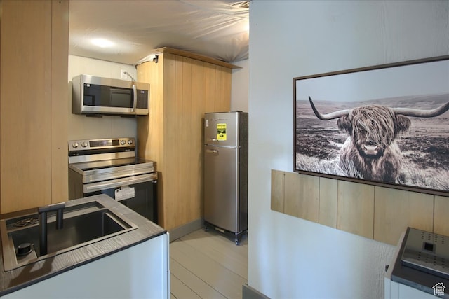 11687 N Shoreline Dr, Hideout, UT 84036 - kitchen with light brown cabinets, light hardwood / wood-style floors, sink, and appliances with stainless steel finishes