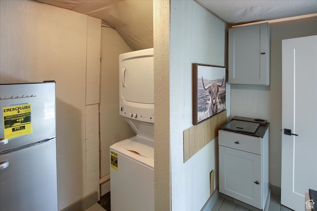 11687 N Shoreline Dr, Hideout, UT 84036 - clothes washing area with light tile patterned flooring and stacked washer / drying machine