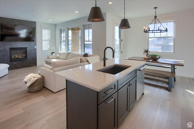 11687 N Shoreline Dr, Hideout, UT 84036 - kitchen featuring a wealth of natural light, decorative light fixtures, a kitchen island with sink, and sink
