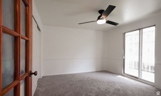 spare room with carpet and ceiling fan