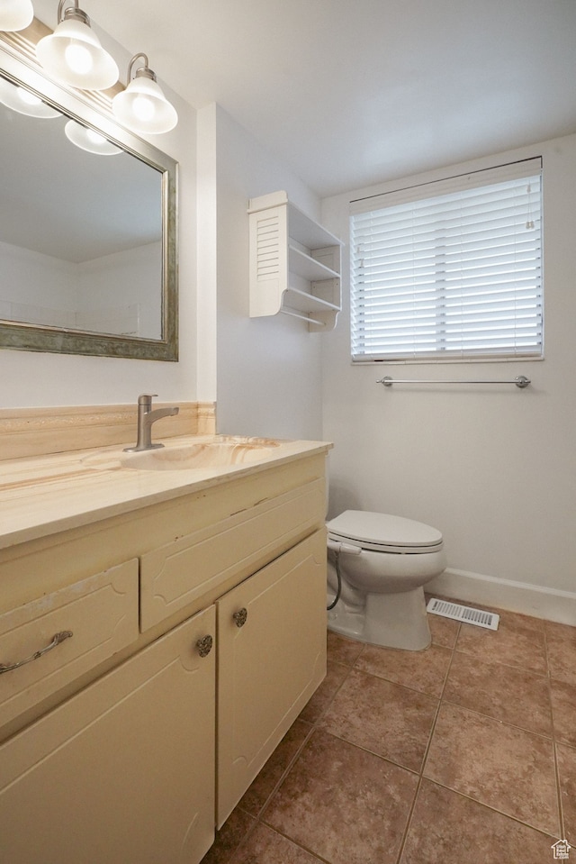 bathroom with tile patterned floors, vanity, and toilet