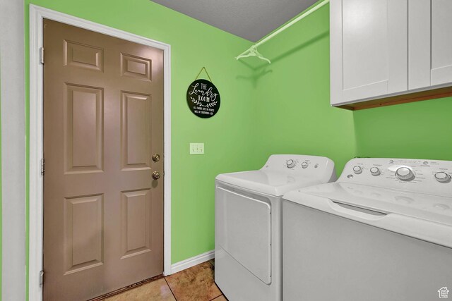 10877 N Wallace Ln E, Tremonton, UT 84337 - washroom with cabinet space, washer and clothes dryer, light tile patterned floors, and baseboards