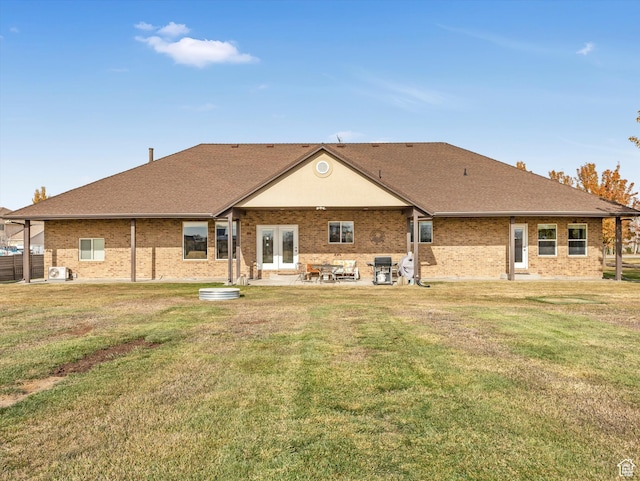 back of house featuring a patio area and a lawn