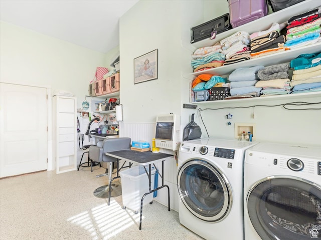 clothes washing area featuring washer and dryer and heating unit