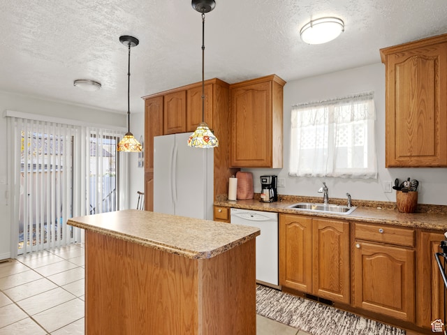 3689 W 5215 S, Taylorsville, UT 84129 - kitchen featuring a sink, pendant lighting, a kitchen island, brown cabinetry, and white appliances