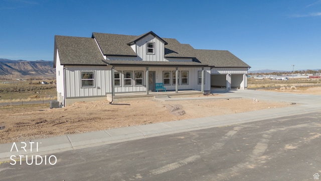 1242 S 500 W Unit 07, Manti, UT 84642 - view of front facade with cooling unit, a garage, a mountain view, and covered porch