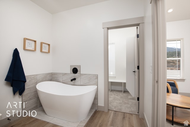 1242 S 500 W Unit 07, Manti, UT 84642 - bathroom featuring tile walls, hardwood / wood-style flooring, and a bathing tub