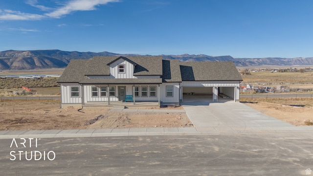 view of front of property featuring a porch, a mountain view, and a carport