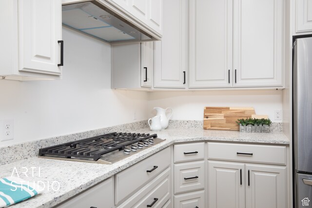 1242 S 500 W Unit 07, Manti, UT 84642 - kitchen with light stone counters, stainless steel appliances, custom range hood, and white cabinets