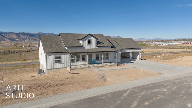 1242 S 500 W Unit 07, Manti, UT 84642 - view of front of property featuring cooling unit, a mountain view, a garage, and covered porch