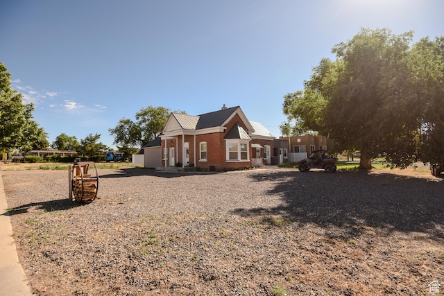 410 N Main St, Beaver, UT 84713 - view of home's exterior with brick siding and a metal roof