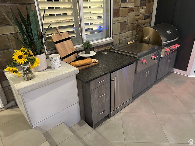 106 E 710 N, Lindon, UT 84042 - kitchen featuring dark brown cabinetry, stainless steel fridge, and light tile patterned floors