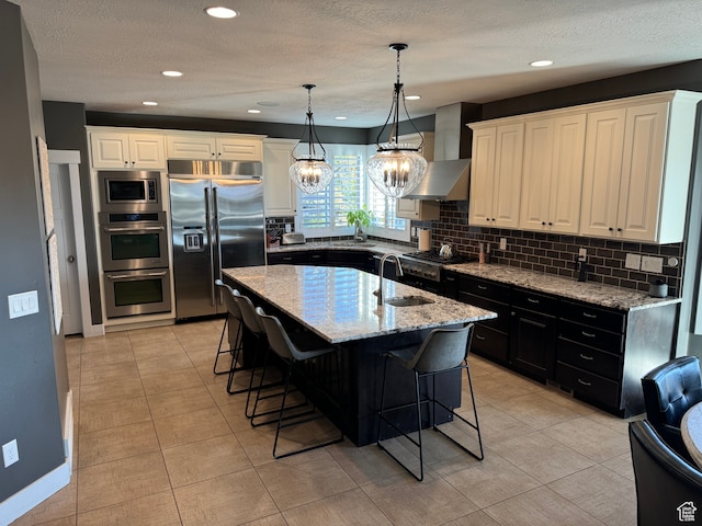106 E 710 N, Lindon, UT 84042 - kitchen with backsplash, ventilation hood, sink, built in appliances, and an island with sink