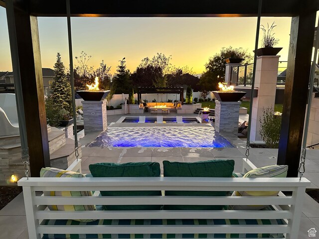 106 E 710 N, Lindon, UT 84042 - pool at dusk with an outdoor living space with a fire pit and a patio area