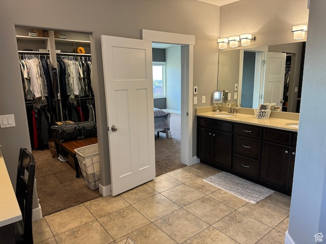 106 E 710 N, Lindon, UT 84042 - ensuite bathroom featuring double vanity, a walk in closet, and tile patterned flooring