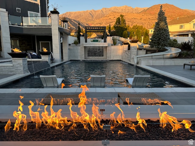 106 E 710 N, Lindon, UT 84042 - view of swimming pool with pool water feature, a patio, a mountain view, and an outdoor fire pit
