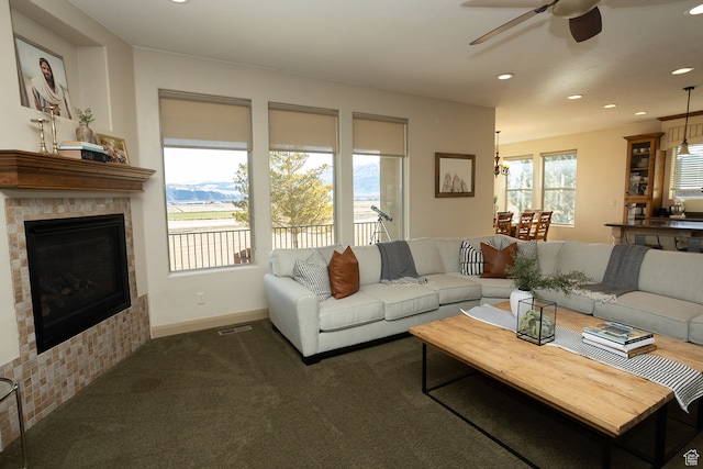 2195 S 1600 W, Richfield, UT 84701 - living room with ceiling fan, a fireplace, a mountain view, and dark colored carpet