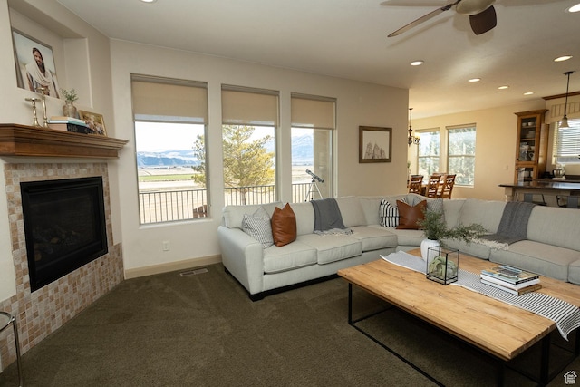 2195 S 1600 W, Richfield, UT 84701 - carpeted living room with a ceiling fan, a tile fireplace, recessed lighting, and baseboards