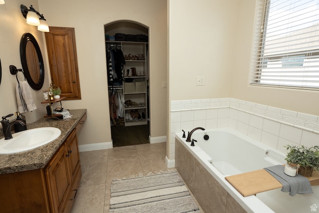 2195 S 1600 W, Richfield, UT 84701 - bathroom with tile patterned floors, vanity, and a relaxing tiled tub