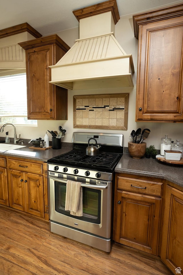 2195 S 1600 W, Richfield, UT 84701 - kitchen featuring stainless steel range with gas cooktop, a sink, custom range hood, and brown cabinetry
