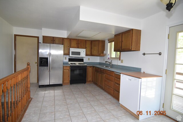 154 W 200 N, Mona, UT 84645 - kitchen with white appliances, brown cabinets, and light tile patterned floors