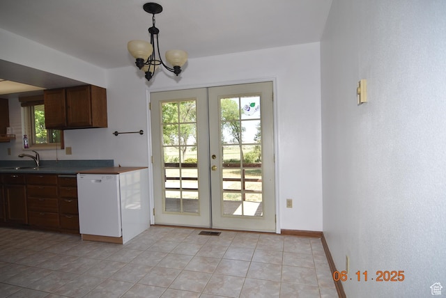 154 W 200 N, Mona, UT 84645 - kitchen featuring dishwasher, french doors, dark countertops, light tile patterned floors, and a chandelier