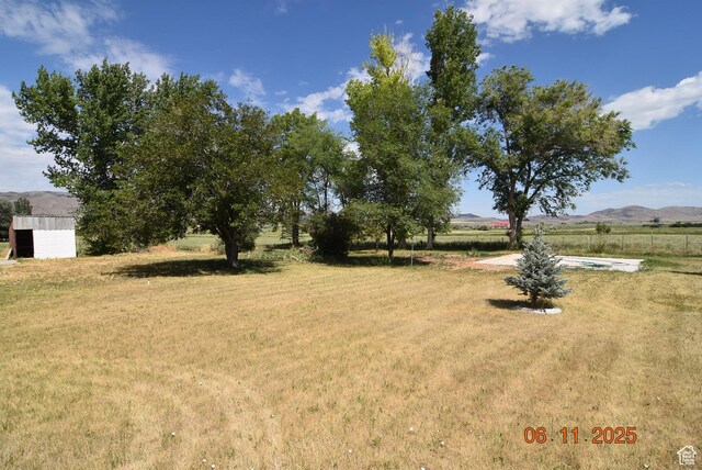154 W 200 N, Mona, UT 84645 - view of grassy yard with a mountain view, a rural view, and a storage unit