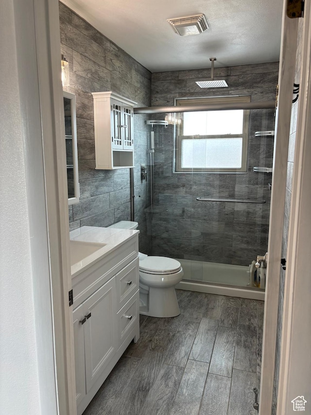 154 W 200 N, Mona, UT 84645 - full bathroom with vanity, a shower stall, tile walls, and wood finished floors