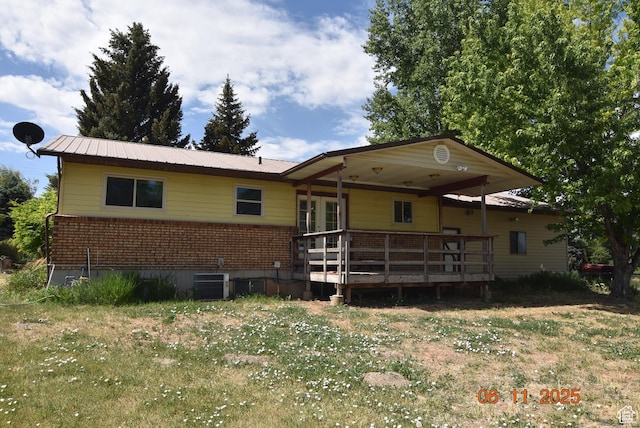 154 W 200 N, Mona, UT 84645 - rear view of house with brick siding, a wooden deck, a metal roof, and french doors