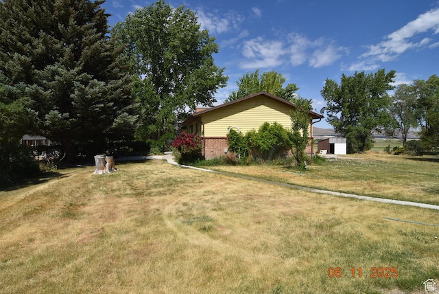 154 W 200 N, Mona, UT 84645 - view of side of home with brick siding and a lawn