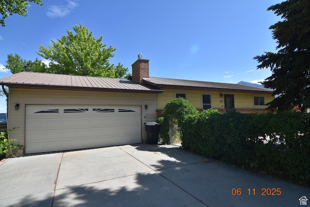 154 W 200 N, Mona, UT 84645 - single story home with a chimney, concrete driveway, a metal roof, and an attached garage