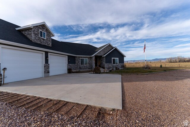5361 N 4500 E, Roosevelt, UT 84066 - craftsman-style home with stone siding, concrete driveway, and a garage
