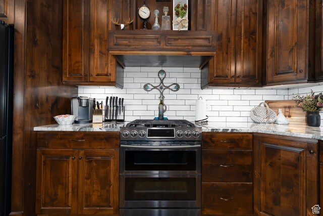 5361 N 4500 E, Roosevelt, UT 84066 - kitchen with range with two ovens, light stone countertops, decorative backsplash, and freestanding refrigerator