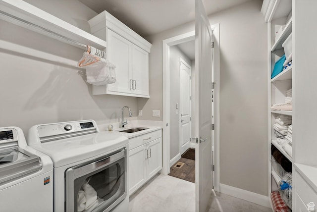 2118 N Snowy Crane Dr, Clinton, UT 84015 - laundry room with washer and clothes dryer, cabinet space, and baseboards